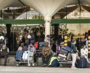 Passengers stranded at the Jomo Kenyatta International Airport.  By SIMON MAINA (AFP)