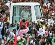 Pope Leo XIV blessed the crowd from a popemobile with bulletproof windows.  By Alberto PIZZOLI (AFP)