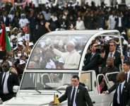Pope Leo XIV travelled to his mass outside the Angolan capital on his popemobile.  By Alberto PIZZOLI (AFP)