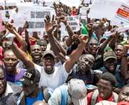 Protesters demand accountability from government leaders at a demonstration in Banjul on July 23, 2025. By MUHAMADOU BITTAYE (AFP)