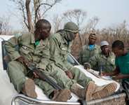 Researcher Martial Kiki (right) fills in data sheets with rangers during a lion population estimate at Nigerias Yankari Game Reserve.  By Stefan Heunis (AFP/File)