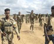 Soldiers of the Somali National Army (SNA) walk near the front line.  By Tony KARUMBA (AFP)