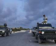 Somalian security officers pray at a security checkpoint on the outskirts of Mogadishu.  By Tony KARUMBA (AFP)