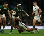 South Africa captain Siya Kolisi (C) in action against England at Twickenham last season..  By Adrian Dennis (AFP)