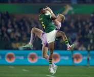 South Africa full-back Aphelele Fassi (L) and Scotland wing Kyle Steyn fight for a high ball..  By PHILL MAGAKOE (AFP)