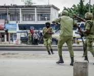 Tanzanian police officers try to disperse protesters on October 29. By - (AFP)