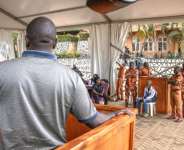 The trial of Christopher Okello Onyum (4th right) was held in a specially erected tent to accommodate spectators.  By Stuart Tibaweswa (AFP)