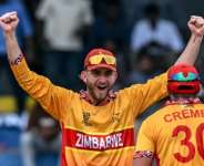 Zimbabwes Brian Bennett (L) celebrates with teammate Graeme Cremer after their teams win against Australia. By Ishara S. KODIKARA (AFP)