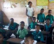 A volunteer assisting basic four pupils at her free time at Avenui E.P. Schools