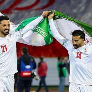 AFP via Getty Images: Iran players Omid Norafkan and Saman Ghoddos celebrate after a qualifying match in 2025