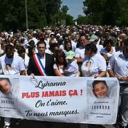 Lyhannas father, Martial Bernard along with Fleurance mayor Gregory Bobbato and Lyhannas mother Charly Rameau hold a sign that says never again at the front of a march in tribute to Lyhanna in Fleurance, 7 June  2026. -  Lionel Bonaventure/AFP