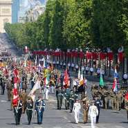 Coalition of volunteers of invited foreign nations march down the Champs-Elyses during the annual Bastille Day military parade, 14 July 2026. - AFP - LUDOVIC MARIN