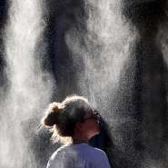 A woman cools off under a mist sprayer during the Fte de la Musique festival in Bordeaux, southwestern France, on 21 June 2026. Much of France remained under heat alerts on Wednesday after the country recorded its hottest day since records began. - AFP - ROMAIN PERROCHEAU
