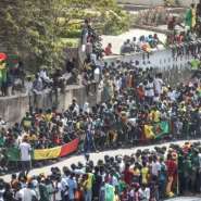 Fans crowd the roads around the Dakar airport waiting for the Senegal team to return in triumph.  By JOHN WESSELS AFP
