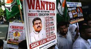 Indian Youth Congress party workers hold placards of Indias Education Minister Dharmendra Pradhan during a protest  over the alleged NEET exam irregularities in Mumbai on June 2, 2026. -  Indranil Mukherjee, AFP
