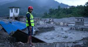 A rescue worker looks on at the site of damaged buildings in the aftermath of flash floods at Trishuli Bazar in Nepals Nuwakot district on August 29, 2026. -  Manan Vatsyayana, AFP