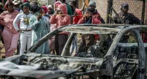 Suspects in the Johannesburg shooting torched two vehicles before fleeing.  By EMMANUEL CROSET (AFP)
