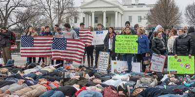 People protest gun violence outside the White House on Feb. 19 following the latest mass school shooting, this one in Florida. Like the teens and children who showed up at the White House and elsewhere to protest, Americans must rediscover themselves as a revolutionary people who are not afraid to start over. Shutterstock