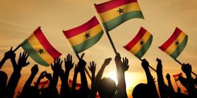 People holding the flag of Ghana.