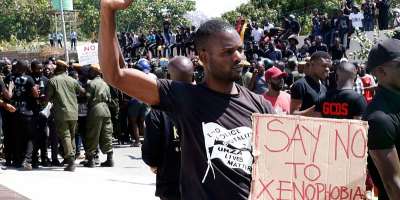 A protestor gestures and holds a placard during a demonstration in front of the South African Embassy in Lusaka, Zambia on September 4, 2019 (Source: CNN)