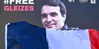 A portrait of French journalist Christophe Gleizes, who is detained in Algeria, is unveiled during a demonstration organised by the Occitanie Press Club and rights group Reporters Without Borders (RSF) to demand his release in Montpellier, southern France on January 29, 2026. -  Gabriel Bouys, AFP