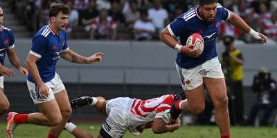Frances Emmanuel Meafou runs with the ball against Japan. -  Andrew Caballero-Reynolds, AFP