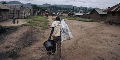 A man carries supplies through Kishishe, eastern Democratic Republic of Congo. Fighting in eastern DRC has displaced millions of people as Rwanda and the DRC seek to implement a US-brokered peace agreement. -  Alexis Huguet / AFP