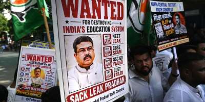 Indian Youth Congress party workers hold placards of Indias Education Minister Dharmendra Pradhan during a protest  over the alleged NEET exam irregularities in Mumbai on June 2, 2026. -  Indranil Mukherjee, AFP