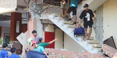 People evacuate from a collapsed building at the Jayakarta hotel in Labuan Bajo, Indonesia, following a powerful earthquake. -  Stringer, Reuters