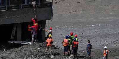 Police personnel rescue stranded residents from houses lying deluged in sludge after flash floods at Trishuli in Nepals Nuwakot district on August 27, 2026. -  Arun Sankar, AFP