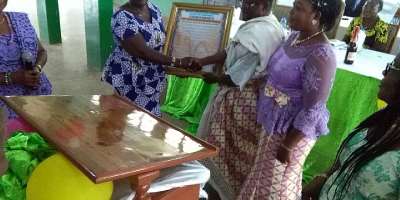 Mr. Ayivi-Tosuh receiving a citation from staff of the Ho West District Education Directotrate