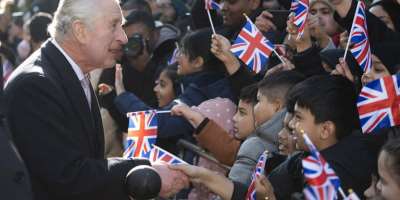 Charles III shakes hands during a visit to Brick Lane in London: The monarch enjoys a special status