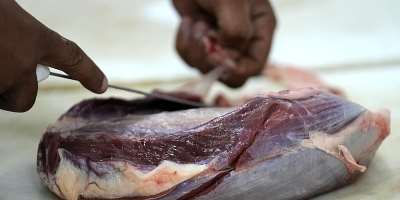An employee prepares cuts of meat in a butcher shop, in Brasilia, Brazil, Monday, Aug. 4, 2025. -  Eraldo Peres, AP