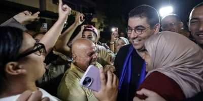 Moroccos Minister of Youth, Culture and Communication and member of the collective leadership of the Authenticity and Modernity Party (PAM), Mohamed Mehdi Bensaid (2nd R), celebrates with party members after the announcement of the provisional results (Abdel Majid BZIOUAT)