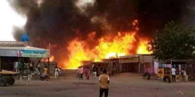A fire burns in the area of a livestock market in El-Fasher, in North Darfur, after a bombardment by the RSF last year.  By - AFPFile