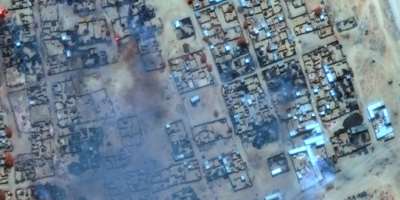 A satellite photo provided by Maxar Technologies shows smoke billowing and buildings burned in Zamzam camp near the besieged city of El-Fasher in Sudans Darfur.  By - (Satellite image 2025 Maxar Technologies/AFP/File)