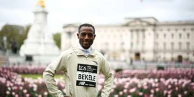 Ethiopia's Kenenisa Bekele poses in front of Buckingham Palace.  By HENRY NICHOLLS AFP
