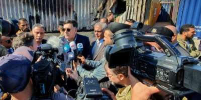 Libya's then-prime minister Fayez al-Sarraj, flanked by journalists, visits Tripoli port after it was hit by rocket fire on February 19, 2020.  By Mahmud TURKIA AFPFile