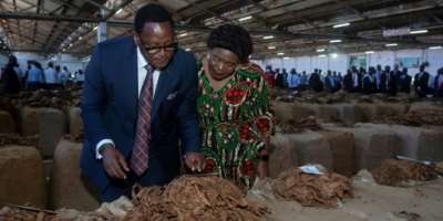President Lazarus Chakwera and his wife marked the opening of the 2025 tobacco trading season.  By Amos Gumulira (AFP)