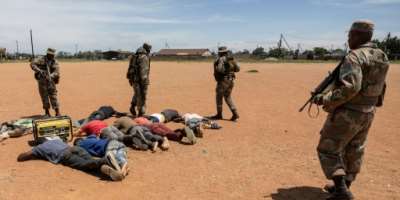 South African soldiers guard detained suspects in the fight against illegal mining in Kagiso, Gauteng Province.  By WIKUS DE WET AFPFile
