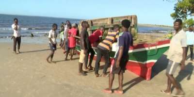 Television footage showed people gathered around the red and green wooden boat which had been pulled onto a beach.  By - TVMAFP