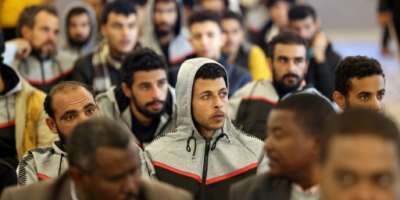 The migrants were dressed in differing tracksuits to identify their nationalities.  By Mahmud Turkia AFP
