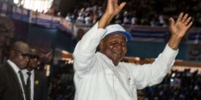 Touadera gestures to supporters at a party rally in Bangui where he announced his candidacy for a third term in December elections.  By Annela NIAMOLO (AFP)