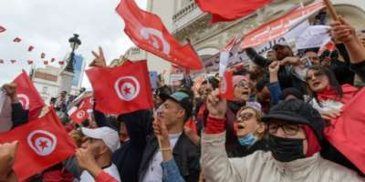 Tunisian demonstrators chant slogans and wave their country's national flag in support of President Kais Saied, in the capital Tunis.  By FETHI BELAID AFP