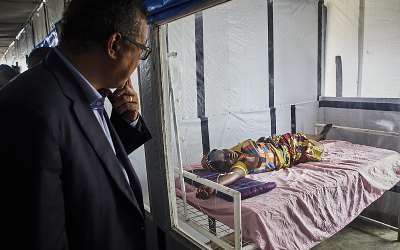 WHO Director-General Tedros Adhanom greets an Ebola patient at a treatment center in North Kivu, DRC. - Source: Hugh Kinsella Cunningham/EPA-EFE