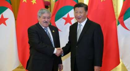 Chinese President Xi Jinping shakes hands with then Algerian prime minister Ahmed Ouyahia in Beijing in 2018. By Lintao Zhang (POOL/AFP/File)
