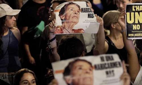 Demonstrators hold signs reading Not a single more Maricarmen during a protest against evictions and high rent prices in Barcelona on October 5, 2026. -  Manaure Quintero, AFP
