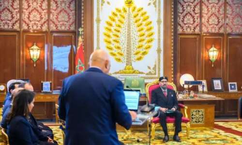 The King of Morocco seated