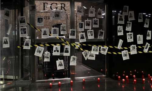 Photos of slain Mexican journalists are placed on the symbolically closed doors of the attorney generals office in Mexico City during a vigil in memory of Fredid Romn Romn, a journalist shot to death in his car in Chilpancingo on August 22, 2022. ReutersHenry Romero