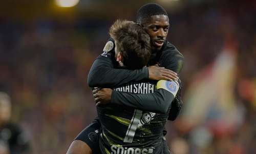 PSGs Khvicha Kvaratskhelia celebrates with teammate Ousmane Dembele after he scored the opening goal during the French League One soccer match between Lens and Paris Saint Germain, in Lens, northern France, on 13 May, 2026. - AP - Jean-Francois Badias